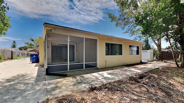 back of house featuring a sunroom