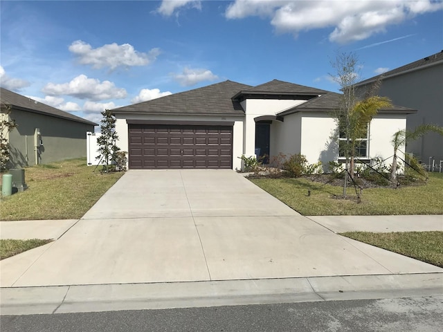 view of front of home featuring a garage and a front lawn