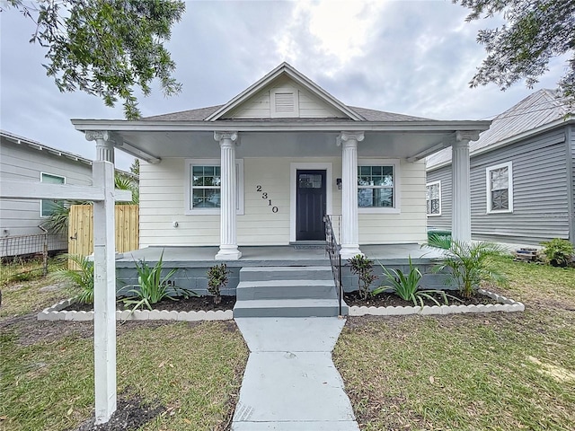 view of front of property with a porch and a front yard