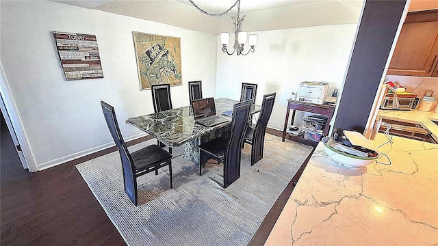 dining space featuring dark hardwood / wood-style flooring and a notable chandelier