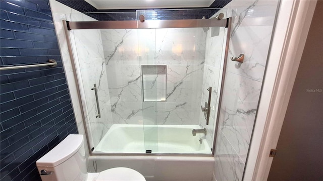 bathroom featuring enclosed tub / shower combo and toilet