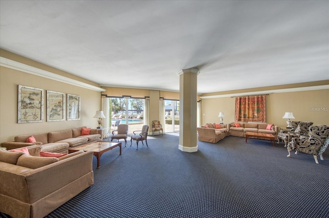 carpeted living room with ornate columns and ornamental molding