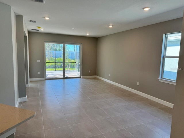 empty room with light tile patterned floors