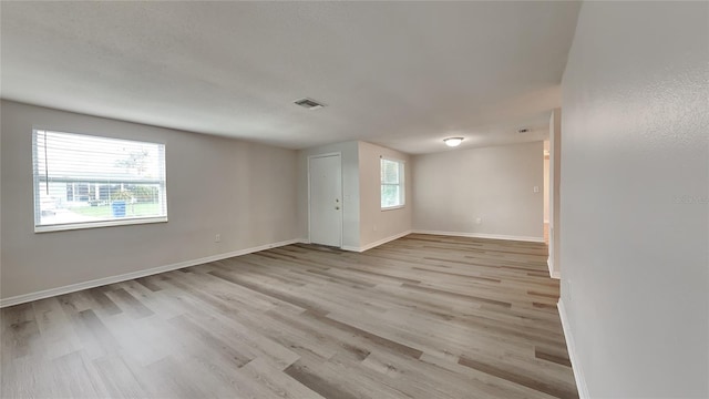 spare room with light hardwood / wood-style floors