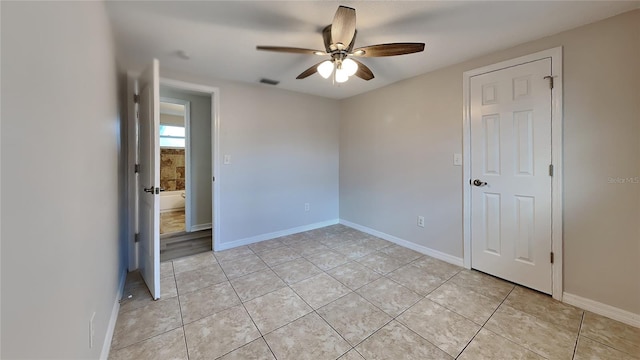 unfurnished room featuring ceiling fan and light tile patterned floors