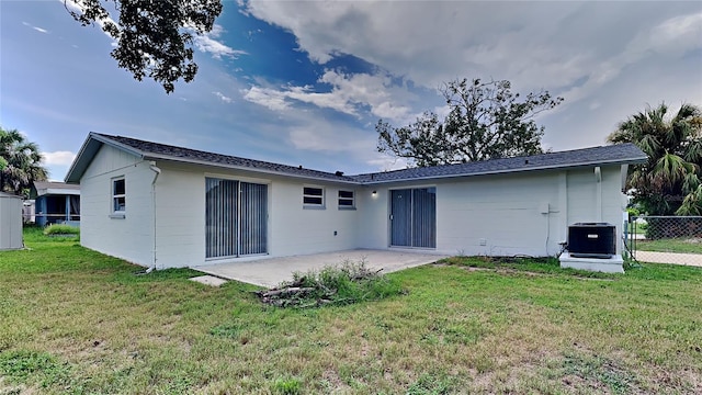 back of property featuring central air condition unit, a yard, and a patio