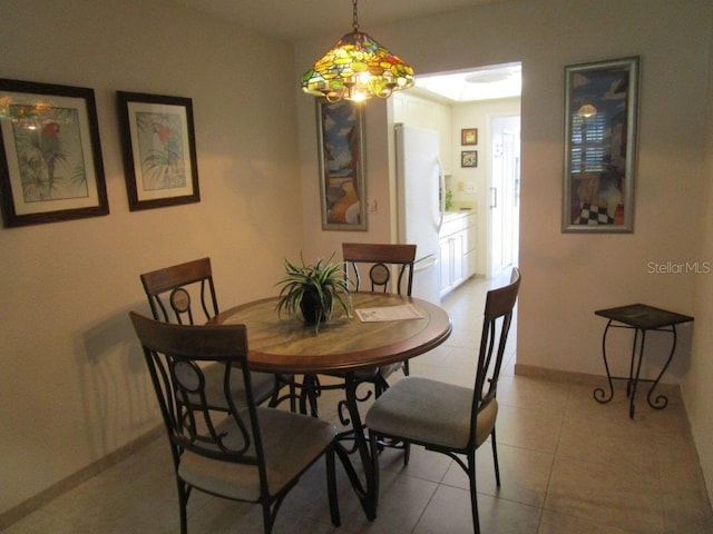 6000 20th St N Unit 114, Saint Petersburg, FL 33714 - dining room featuring baseboards and light tile patterned flooring