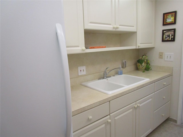 6000 20th St N Unit 114, Saint Petersburg, FL 33714 - kitchen featuring a sink, white cabinets, light countertops, and open shelves