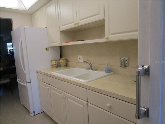 6000 20th St N Unit 114, Saint Petersburg, FL 33714 - kitchen with a sink, light countertops, and white cabinets