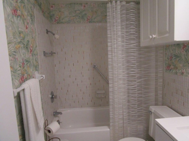 6000 20th St N Unit 114, Saint Petersburg, FL 33714 - bathroom with shower / bath combo, toilet, tile walls, and vanity