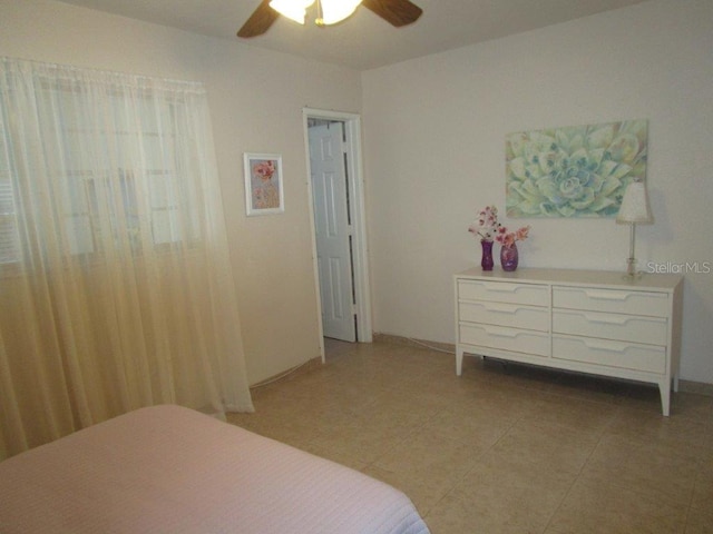 6000 20th St N Unit 114, Saint Petersburg, FL 33714 - bedroom with light tile patterned floors and a ceiling fan