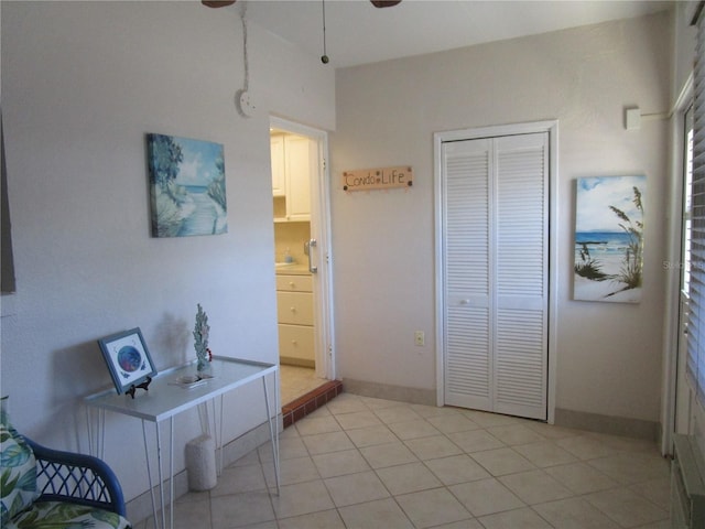 6000 20th St N Unit 114, Saint Petersburg, FL 33714 - bedroom featuring a closet, baseboards, light tile patterned floors, and ceiling fan