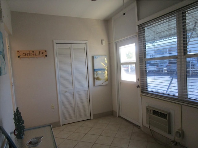 6000 20th St N Unit 114, Saint Petersburg, FL 33714 - doorway to outside featuring a wall unit AC and light tile patterned flooring