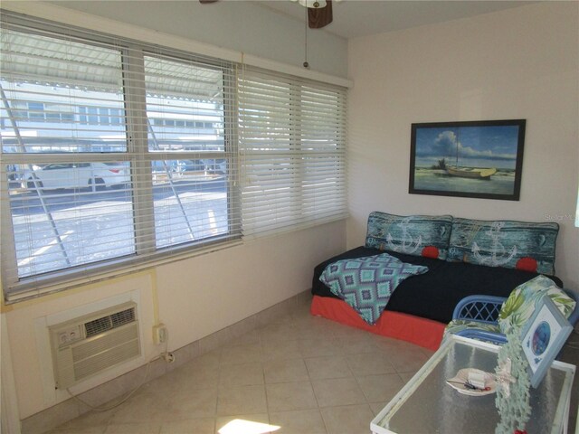 6000 20th St N Unit 114, Saint Petersburg, FL 33714 - living area featuring ceiling fan, healthy amount of natural light, light tile patterned floors, and an AC wall unit