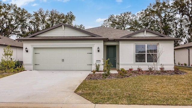 single story home with a garage and a front lawn