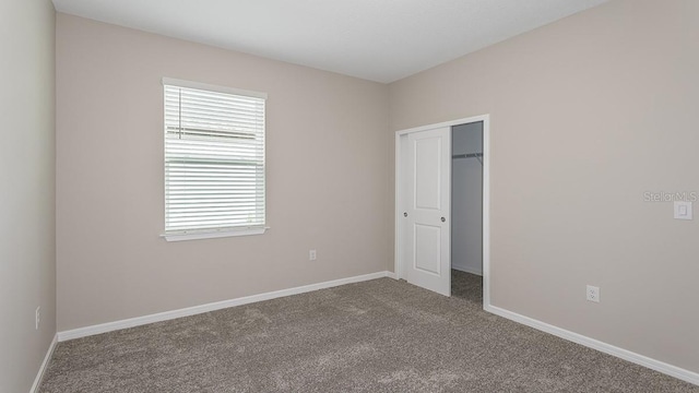 unfurnished bedroom with carpet and a closet