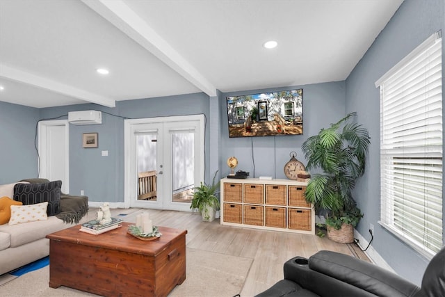 living room with plenty of natural light, beam ceiling, light wood-type flooring, and a wall unit AC