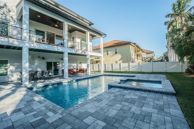 view of pool with a patio area, an in ground hot tub, ceiling fan, and an outdoor living space