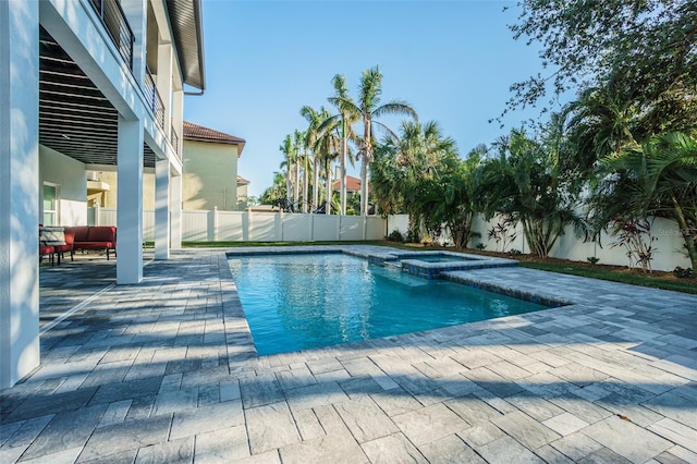 view of swimming pool with a patio area and an in ground hot tub