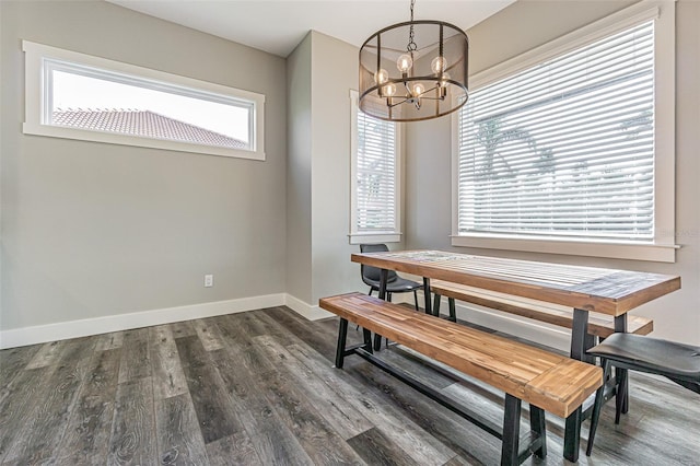 dining area with a chandelier, plenty of natural light, and dark wood-type flooring