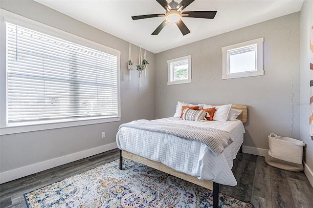 bedroom with ceiling fan and dark hardwood / wood-style flooring