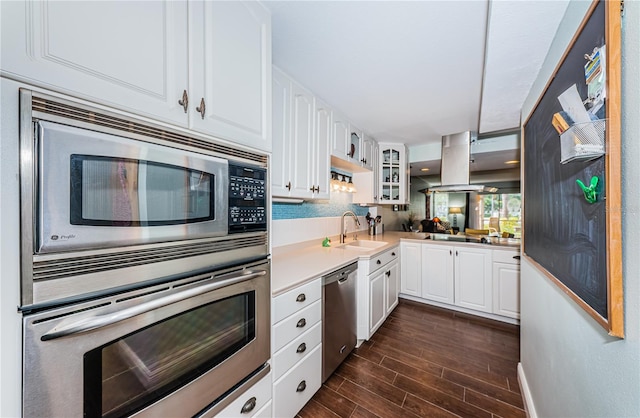 kitchen featuring island range hood, sink, white cabinetry, and stainless steel appliances