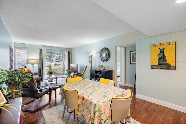 dining space with dark hardwood / wood-style floors