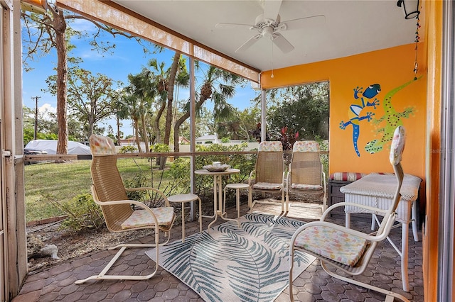 sunroom / solarium featuring ceiling fan