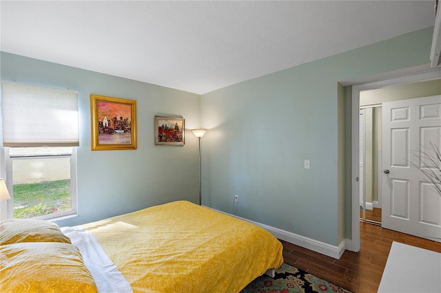 bedroom with dark hardwood / wood-style flooring