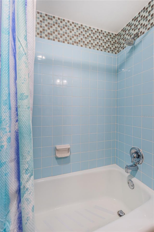 bathroom featuring shower / bathtub combination with curtain