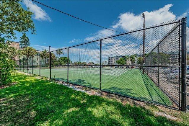 view of sport court featuring a lawn