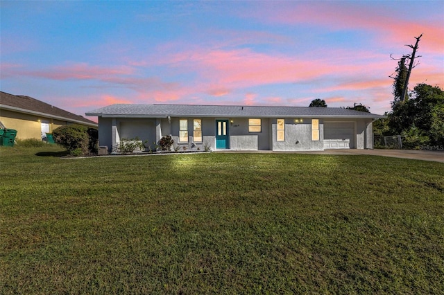 single story home with a lawn and a garage