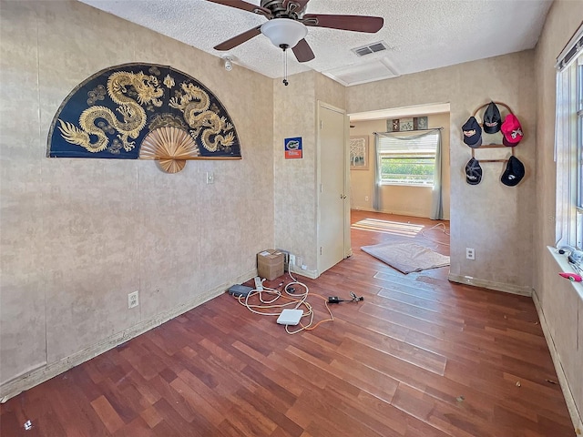 interior space featuring hardwood / wood-style floors, a textured ceiling, and ceiling fan