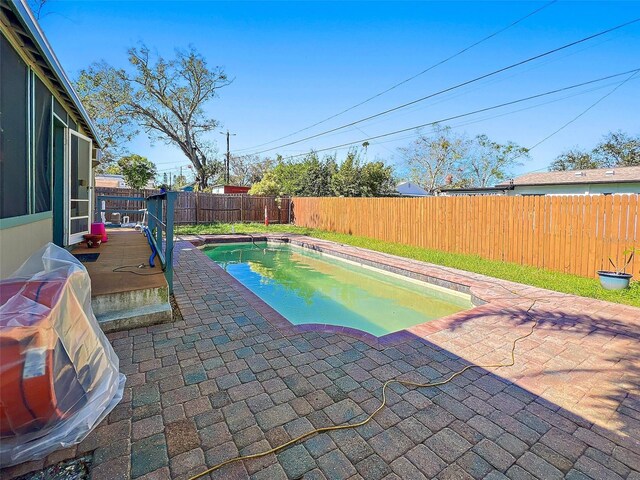 view of swimming pool with a patio