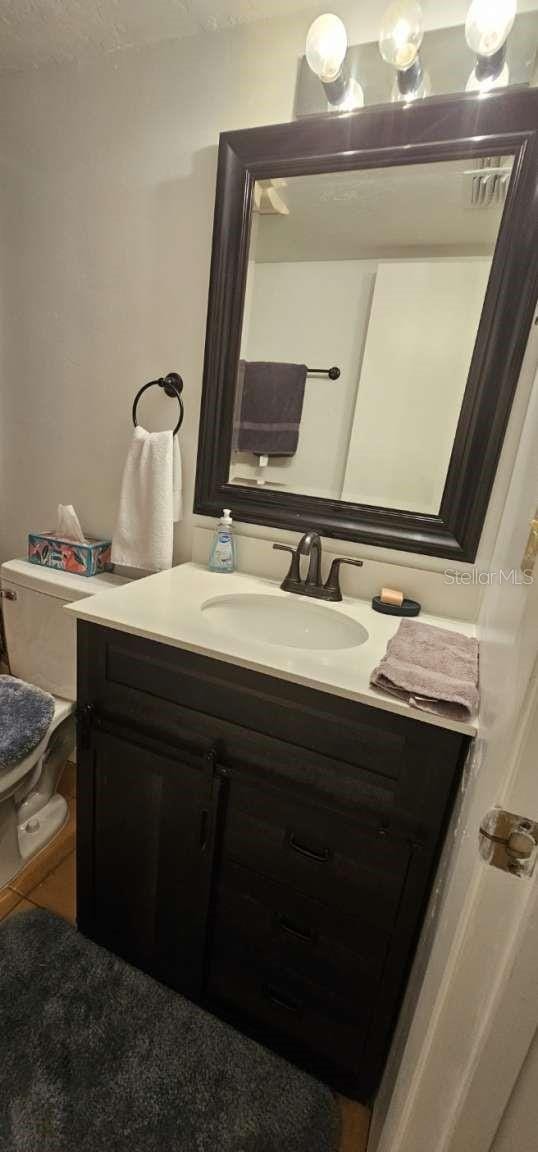 bathroom with vanity and toilet