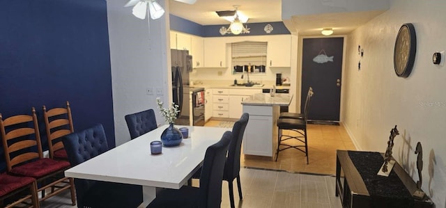 dining area featuring light tile patterned flooring and sink