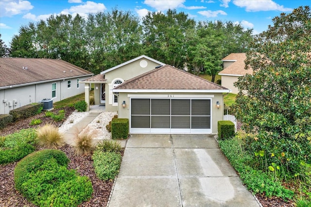 view of front of property with a garage and central air condition unit