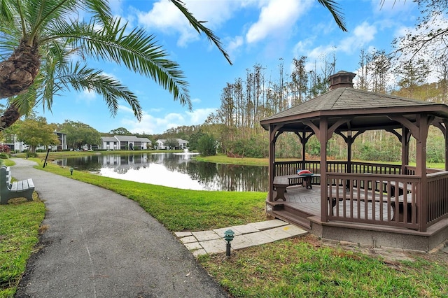 view of property's community featuring a water view, a yard, and a gazebo