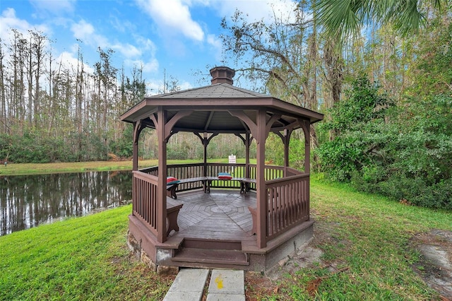 exterior space featuring a water view, a lawn, and a gazebo