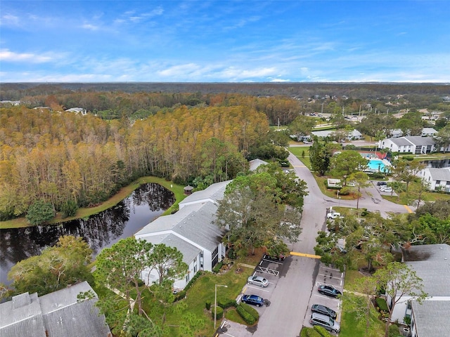 aerial view featuring a water view and a forest view