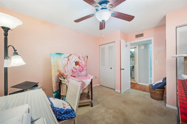 bedroom with carpet floors, visible vents, ceiling fan, and baseboards