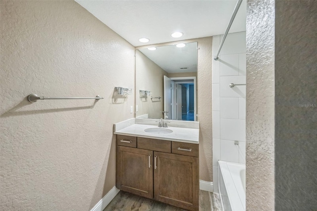 bathroom featuring vanity,  shower combination, and hardwood / wood-style flooring