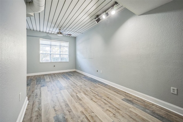 empty room with light hardwood / wood-style floors, ceiling fan, and wooden ceiling