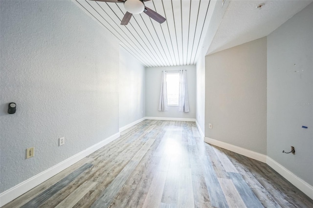 unfurnished room with ceiling fan, wood-type flooring, lofted ceiling, and wooden ceiling