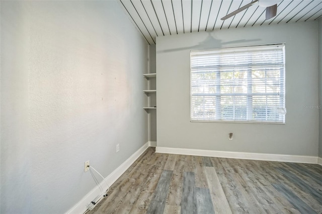 unfurnished room with wooden ceiling, ceiling fan, and wood-type flooring