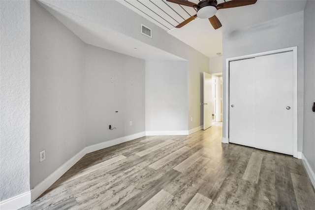 unfurnished room featuring ceiling fan, wood-type flooring, and vaulted ceiling