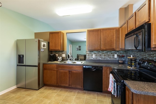 kitchen with black appliances, light tile patterned flooring, sink, and tasteful backsplash