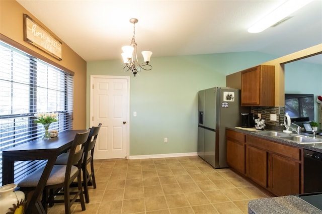 kitchen with decorative backsplash, lofted ceiling, sink, and a chandelier