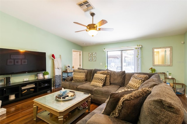 living room featuring dark hardwood / wood-style floors, ceiling fan, and lofted ceiling