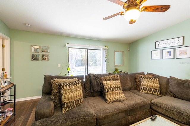 living room featuring vaulted ceiling, ceiling fan, and dark wood-type flooring